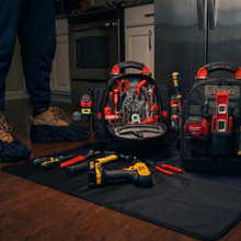 Load image into Gallery viewer, Tool mat, tool bags and tools on a kitchen floor with a person partially visible.